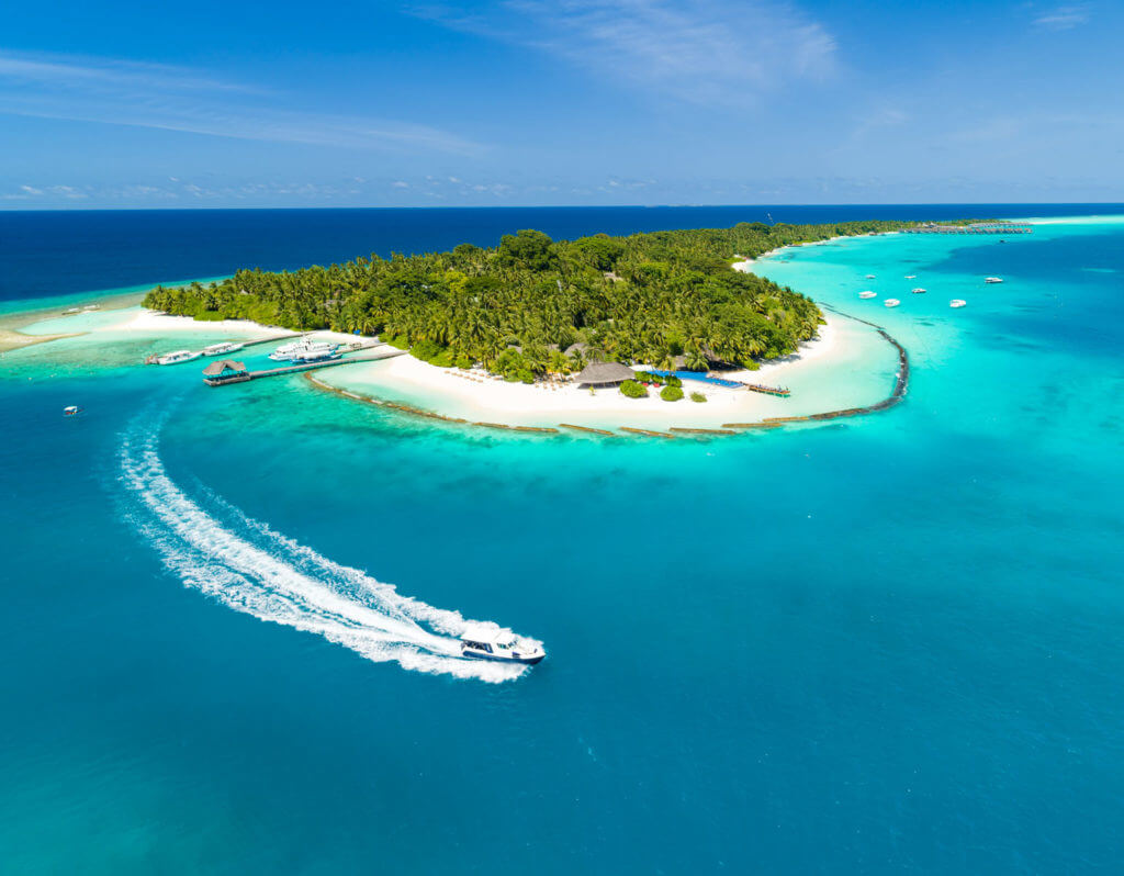 Gran isla en las Maldivas rodeada por el azul del Océano Índico
