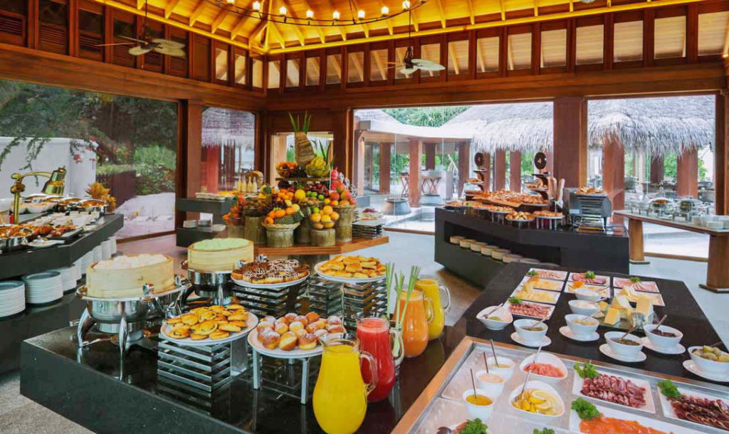 Breakfast table with fruit platter, flatbread and coffee