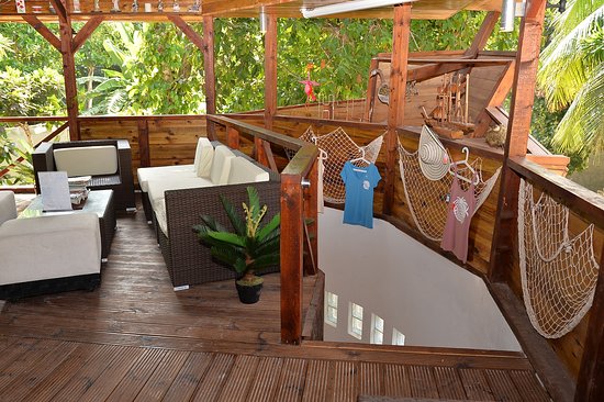 Wooden terrace with sofas and hammocks at a Thoddoo cafe